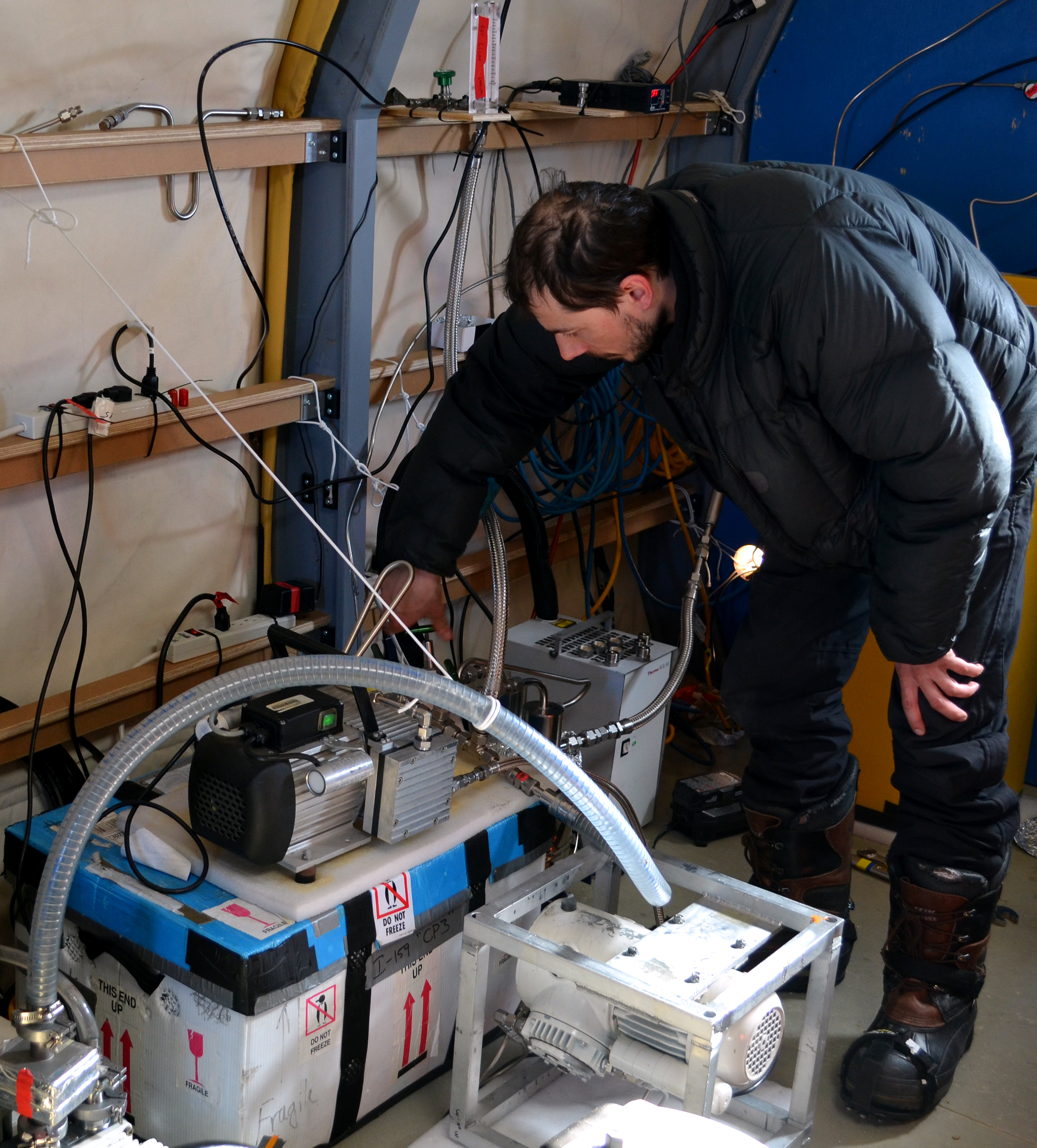Person works with wires and tubes.
