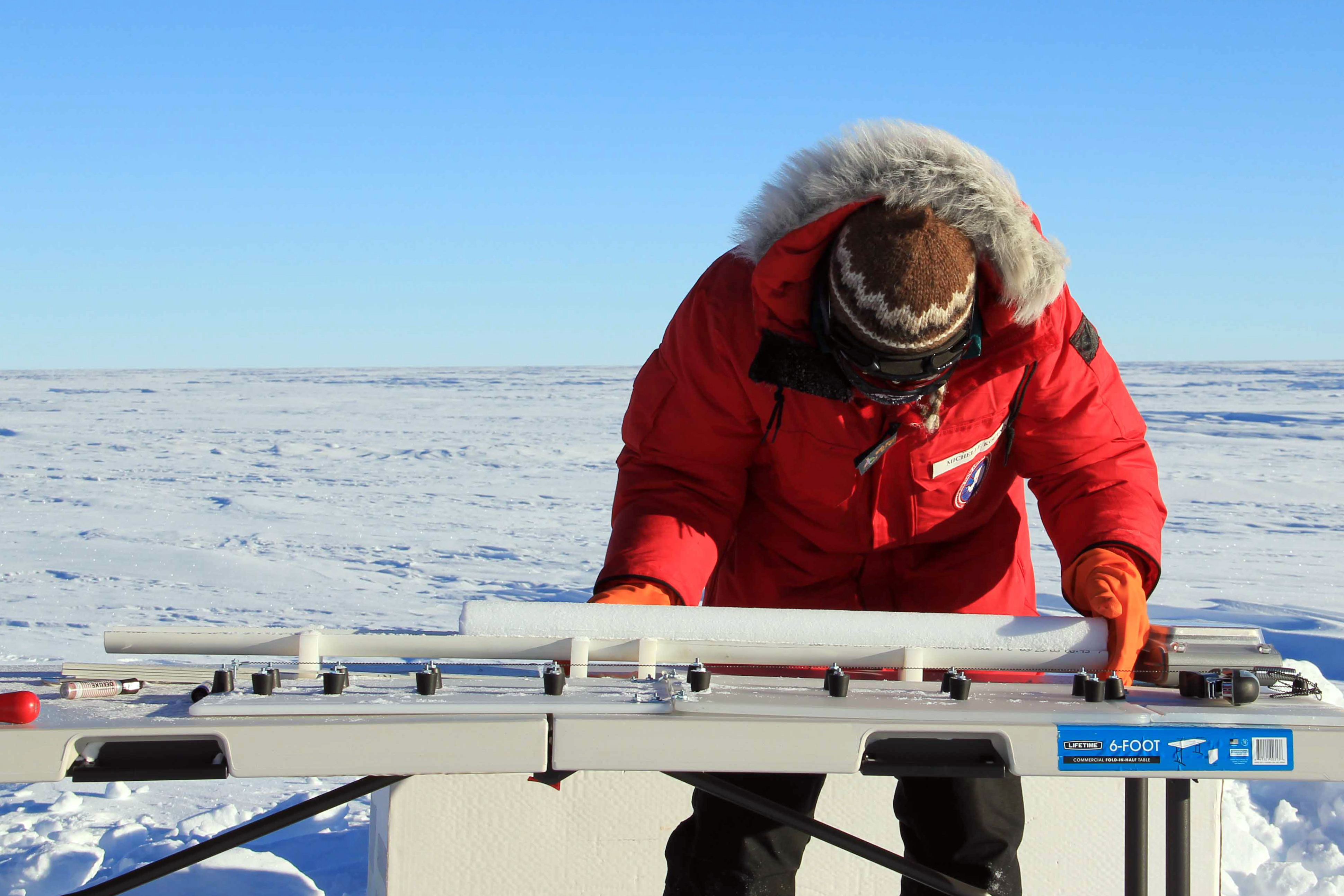 Person measures tube of ice.